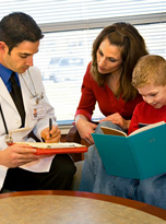 mother and child sitting with doctor